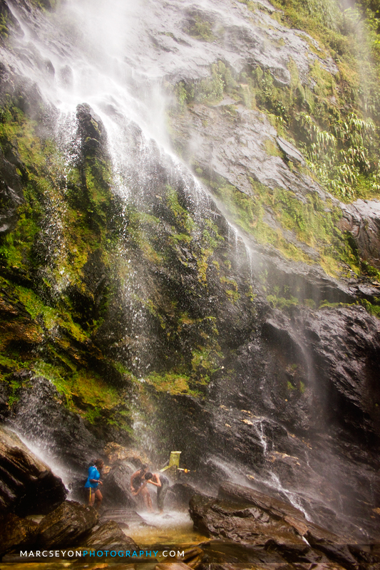 Photo walkers at play under the Maracas Waterfall, Marc Seyon Photo walkers at play under the Maracas Waterfall, Marc Seyon