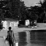 Fisherman walking along Sandy Bay Fisherman walking along Sandy Bay